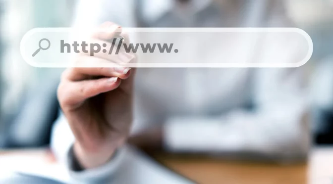 Imagem desfocada de pessoa escrevendo a URL de um site para provedor de internet em uma barra de pesquisa.